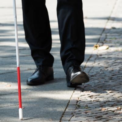 Man walking with a visually impaired stick