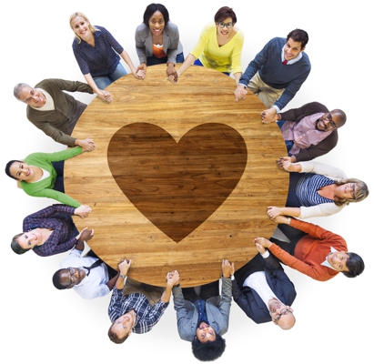 people around a table with a heart on it